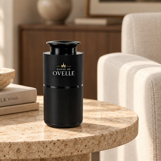 Ovelle Nomad in matte black on a stone side table in a living room