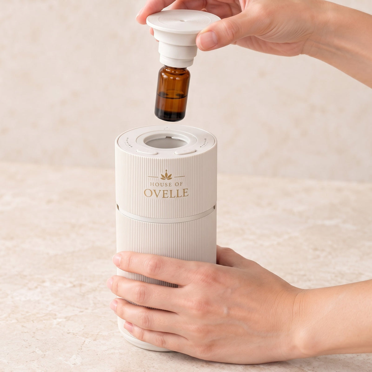 Refilling an Ovelle Nomad in matte white with a fragrance oil bottle