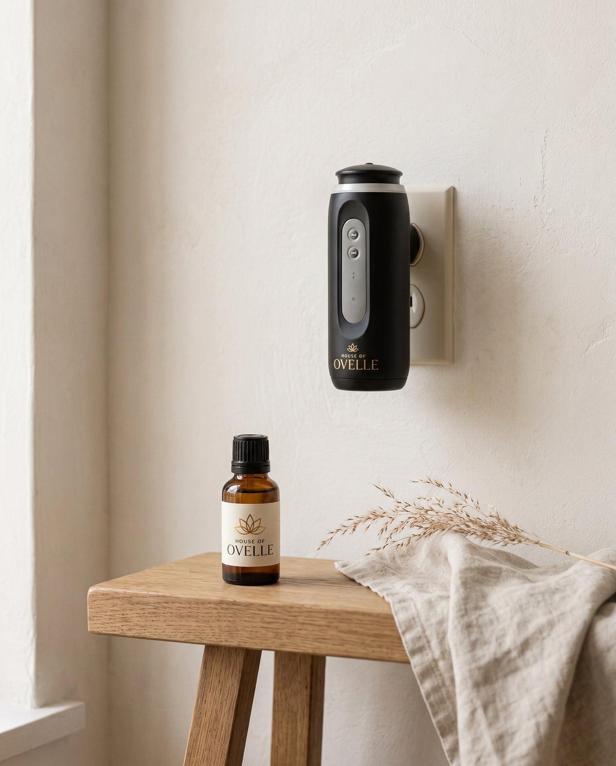 Ovelle Halo plug-in diffuser and fragrance oil on a console