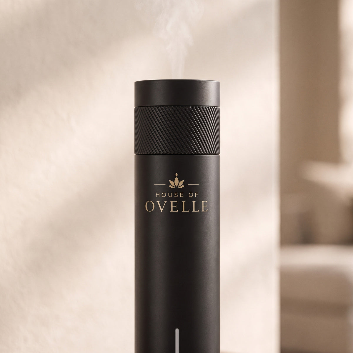 Close detail of the knurled ring and mist outlet of the Ovelle Air in matte black