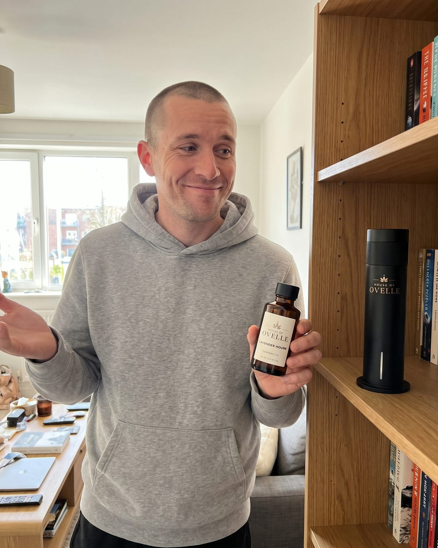 Ovelle Air on a bookshelf with a bottle of Lavender Hours fragrance oil at home