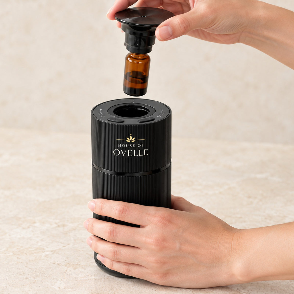 Refilling an Ovelle Nomad in matte black with a fragrance oil bottle