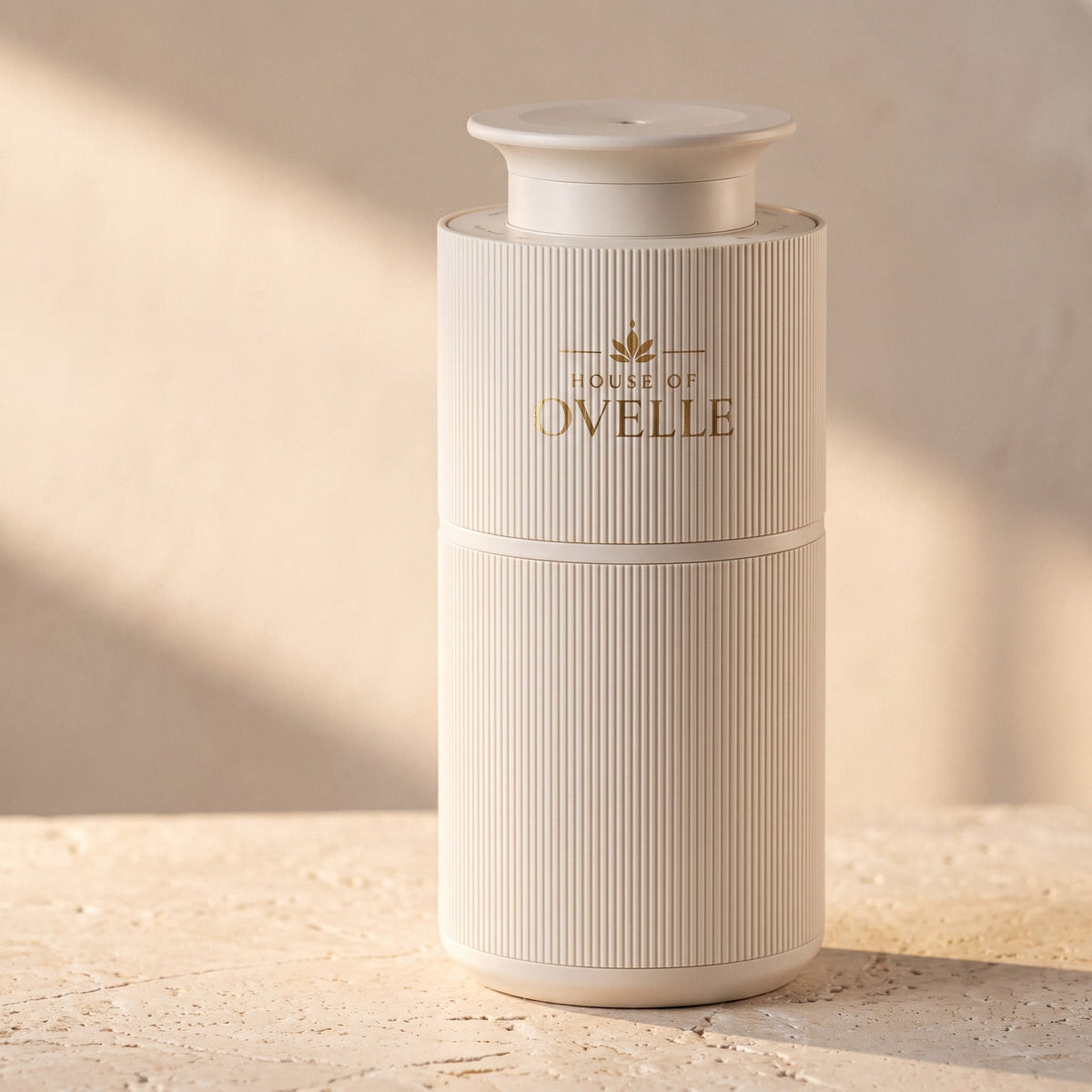 Ovelle Nomad portable diffuser in matte white on a travertine surface