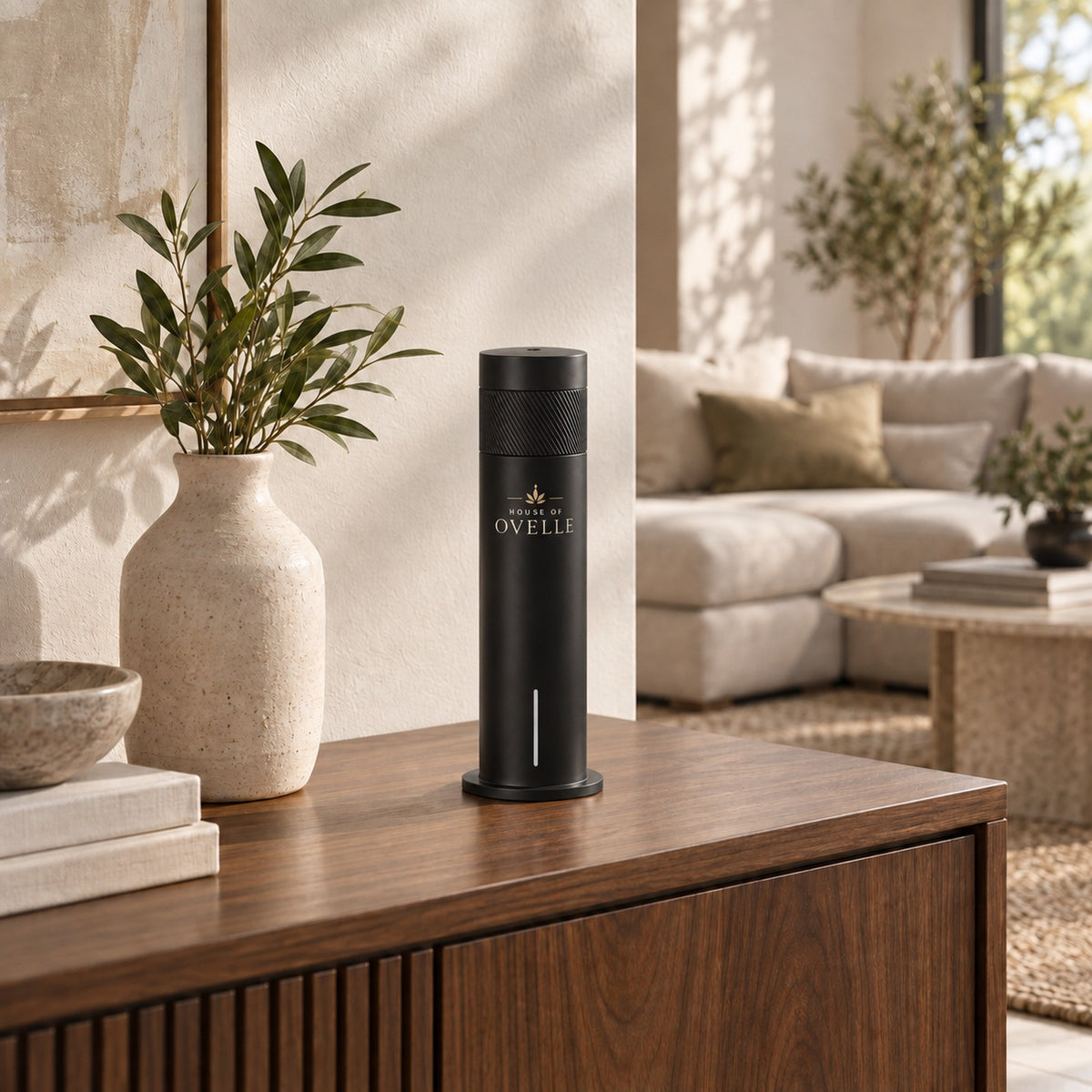 Ovelle Air in matte black on a walnut console in a warm living room